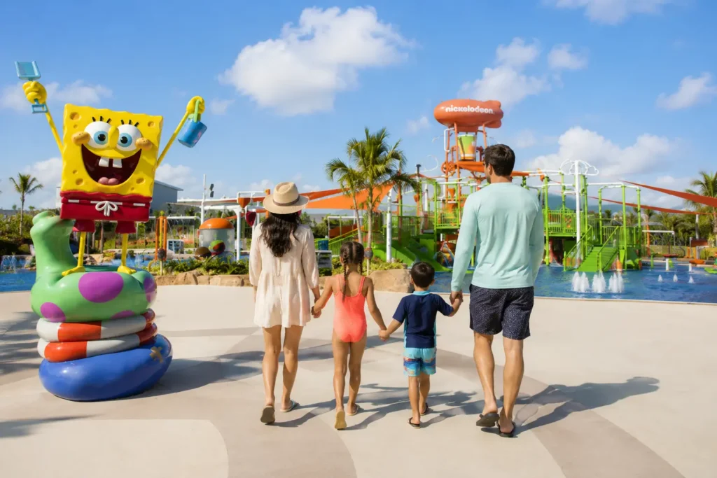 Family enjoying the Nickelodeon Hotels & Resorts Punta Cana water park with SpongeBob attraction, colorful splash zone, and tropical resort setting in Punta Cana.