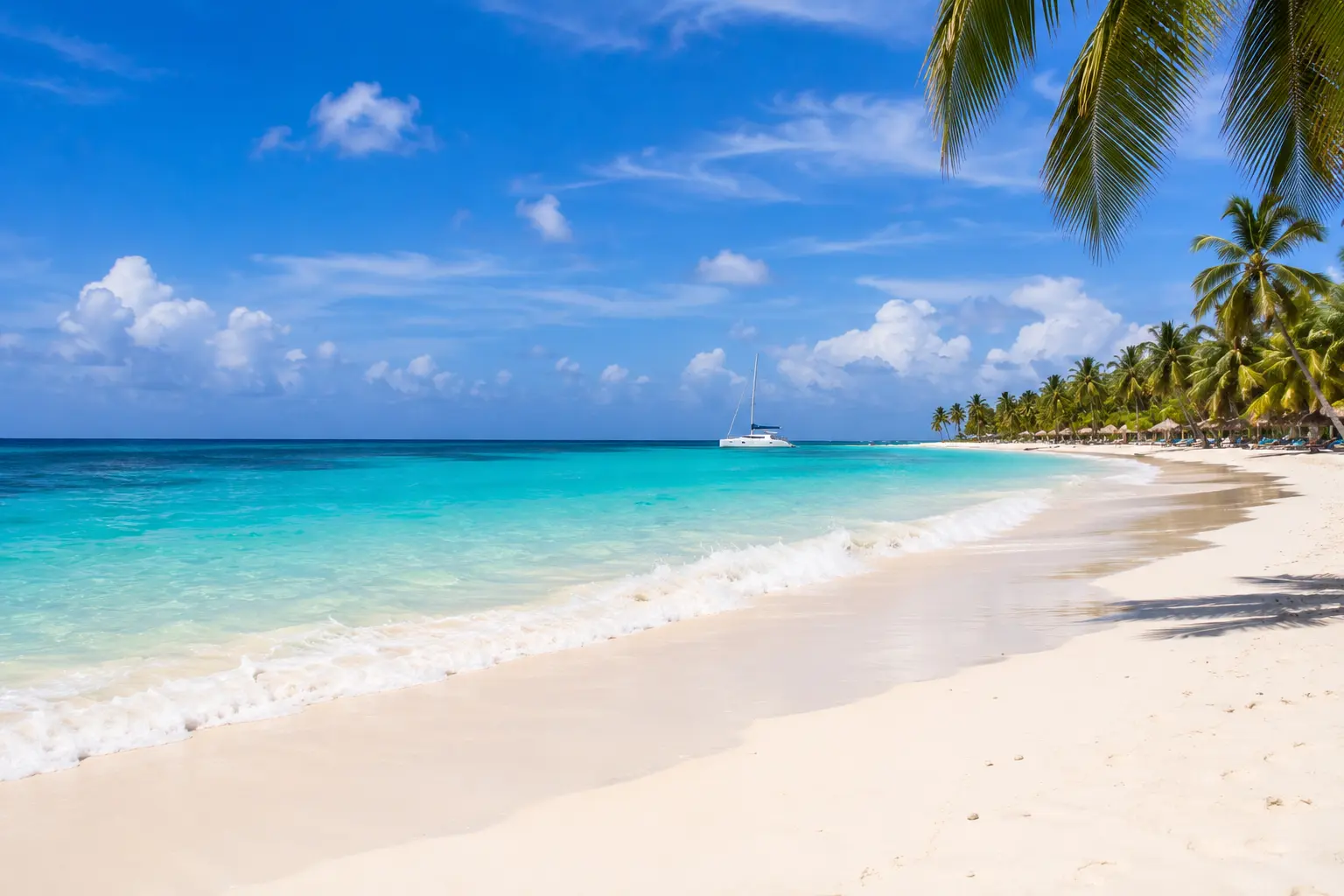 Punta Cana weather on a sunny tropical beach with crystal-clear Caribbean water, white sand, calm waves, and clear blue skies ideal for a beach vacation.