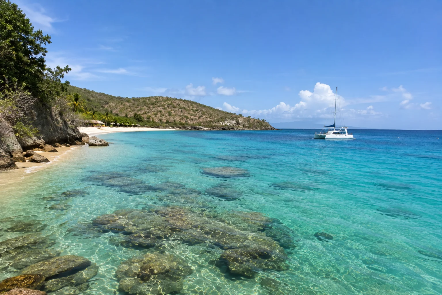 Catalina Island Dominican Republic Snorkeling Guide featuring a tropical cove with clear turquoise water, coral reefs, and a catamaran.